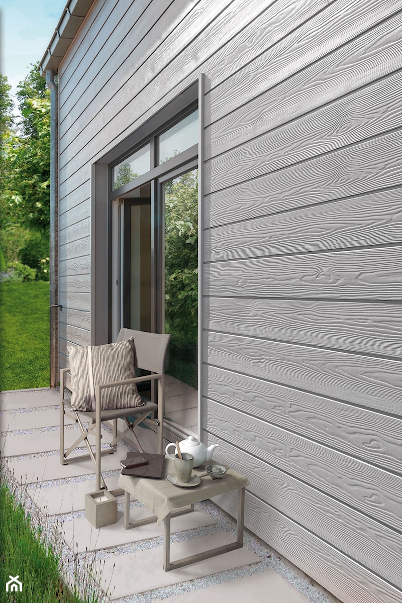 Aranżacje - Mały z podłoga z płyt betonowych z meblami ogrodowymi taras z tyłu domu, styl minimalistyczny - zdjęcie od CEDRAL