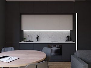 Port Praski - Średnia otwarta z salonem z kamiennym blatem czarna szara z zabudowaną lodówką z lodówką wolnostojącą z nablatowym zlewozmywakiem kuchnia jednorzędowa z marmurem nad blatem kuchennym, styl minimalistyczny - zdjęcie od Studio 36m2