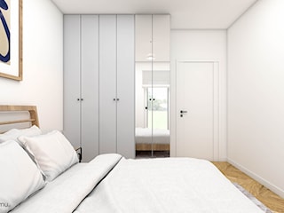 Minimalistyczna sypialnia z drewnianym łóżkiem