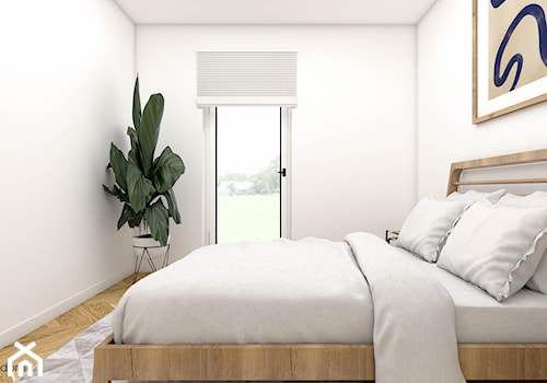 Minimalistyczna sypialnia z drewnianym łóżkiem - zdjęcie od wnetrzewdomu