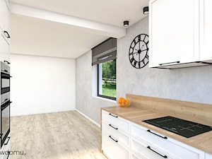 Klasyczna i elegancka biała kuchnia z drewnianym blatem - zdjęcie od wnetrzewdomu