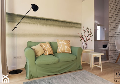 Rozkładana sofa w zielonym kolorze - zdjęcie od studio98