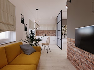 Apartament z aneksem kuchennym i żółtą sofą - zdjęcie od studio98