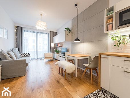 Aranżacje wnętrz - Salon: Apartament w Wilanowie - Średni biały salon z kuchnią z jadalnią z tarasem / balkonem, styl skandynawski - Fotownętrza. Przeglądaj, dodawaj i zapisuj najlepsze zdjęcia, pomysły i inspiracje designerskie. W bazie mamy już prawie milion fotografii!