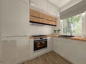 Salon z kuchnią w domu jednorodzinnym - Średnia otwarta z salonem szara z zabudowaną lodówką z nablatowym zlewozmywakiem kuchnia w kształcie litery l z oknem - zdjęcie od QL Home