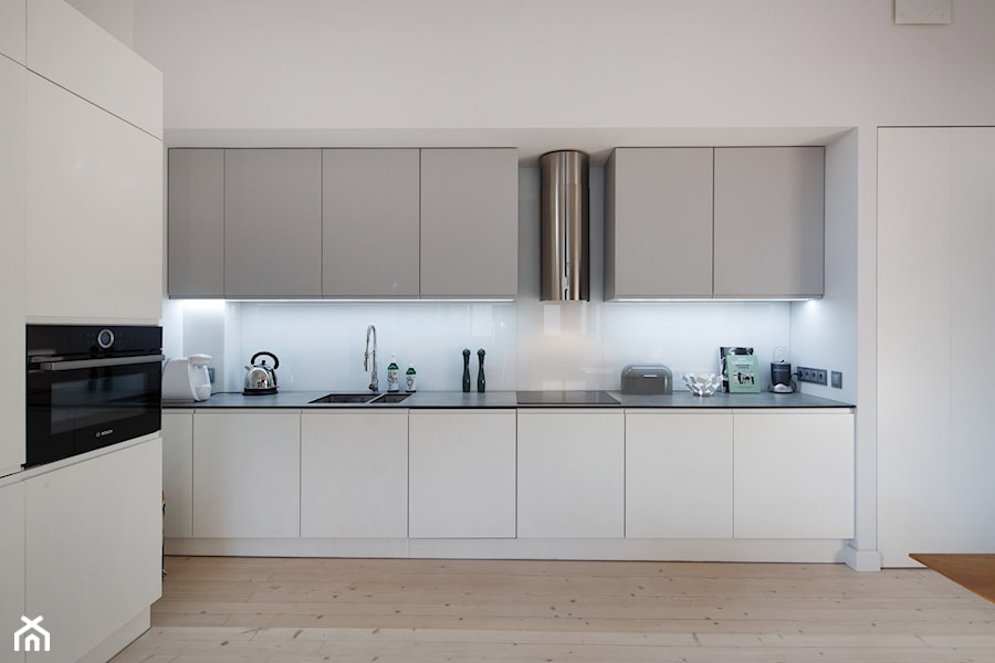 Przytulne mieszkanie - Średnia otwarta z kamiennym blatem biała z zabudowaną lodówką z lodówką wolnostojącą z podblatowym zlewozmywakiem kuchnia w kształcie litery l - zdjęcie od DNAarchitekci