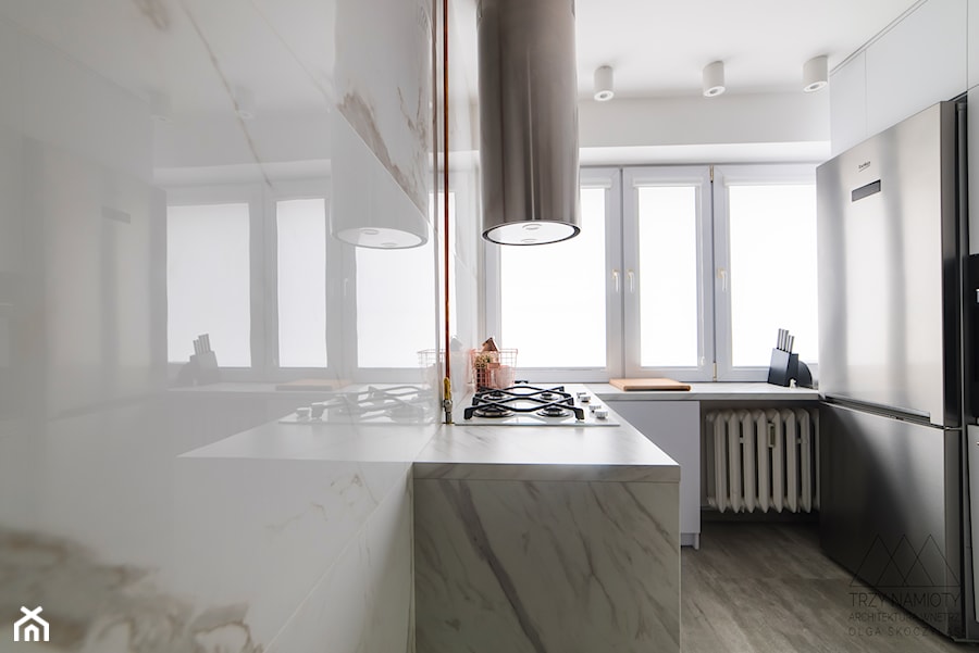 Mieszkanie w wielkiej płycie - Mała zamknięta biała z zabudowaną lodówką kuchnia w kształcie litery u z oknem z marmurem nad blatem kuchennym, styl minimalistyczny - zdjęcie od Trzy Namioty