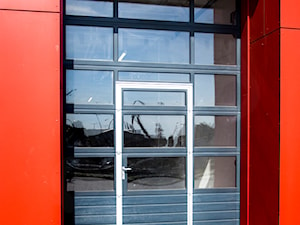 Brama segmentowa z przeszkleniem i drzwiami - zdjęcie od OLBUD OGRODZENIA BRAMY DRZWI I OKNA STRASZYN