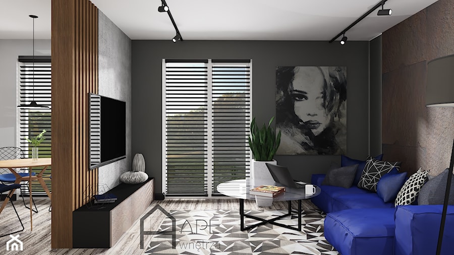 Salon z niebieską sofą i efektem rdzy na ścianie - zdjęcie od APE wnętrza