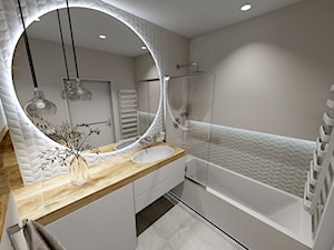 Jasna łazienka z dużym okrągłym lustrem - zdjęcie od Qualita Interno