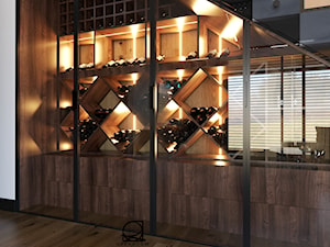 Winnica - miejsce na wino pod schodami w czarnych ramach i oświetleniem led - zdjęcie od Open Room Projekty Wnętrz
