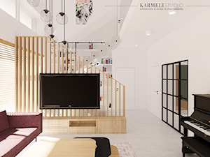 Salon z betonową podłogą i drewnianą zabudową RTV z lameli - zdjęcie od Karmeli Studio