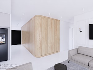 Salon z betonową podłogą i drewnianą ścianą - zdjęcie od Karmeli Studio