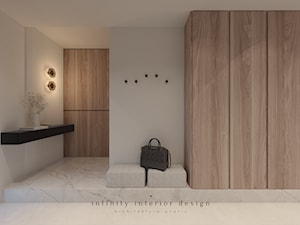 Przedpokój z dużą szafą i siedziskiem - zdjęcie od Infinity Interior Design