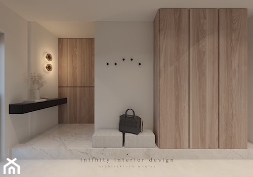 Przedpokój z dużą szafą i siedziskiem - zdjęcie od Infinity Interior Design