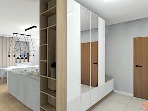 Apartament w bieli, drewnie i betonie. - Średni szary hol / przedpokój, styl nowoczesny - zdjęcie od Studio M Kropki. Projektowanie wnętrz i form użytkowych.