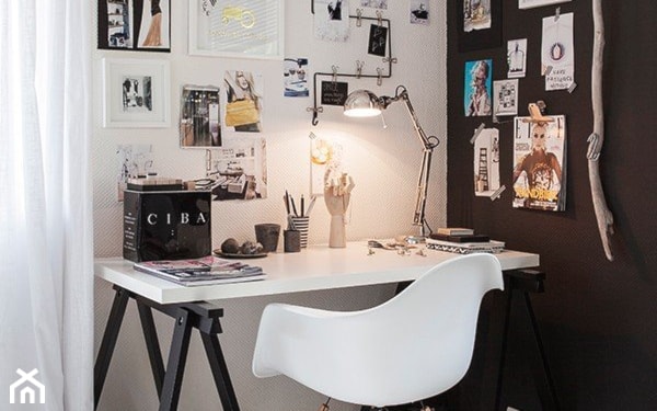 białe biurko z czarnymi nóżkami, metalowa lampka pix, grafiki na ścianie bez ramek