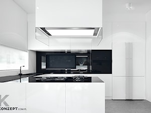Rzeszotary - Średnia otwarta z salonem biała z zabudowaną lodówką z nablatowym zlewozmywakiem kuchnia w kształcie litery l z kompozytem na ścianie nad blatem kuchennym, styl minimalistyczny - zdjęcie od KONZEPT Architekci