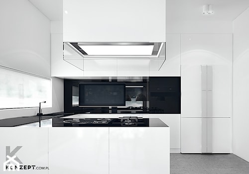 Rzeszotary - Średnia otwarta z salonem biała z zabudowaną lodówką z nablatowym zlewozmywakiem kuchnia w kształcie litery l z kompozytem na ścianie nad blatem kuchennym, styl minimalistyczny - zdjęcie od KONZEPT Architekci