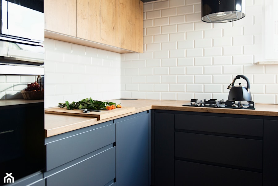 Kuchnia-grafit, biel i drewno - Mała otwarta biała z zabudowaną lodówką kuchnia z granatowymi frontami w kształcie litery l z oknem, styl nowoczesny - zdjęcie od Renee's Interior Design