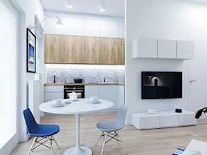 Kawalerka w błękicie - Mała otwarta z salonem biała z zabudowaną lodówką z nablatowym zlewozmywakiem kuchnia w kształcie litery l z oknem, styl nowoczesny - zdjęcie od Renee's Interior Design