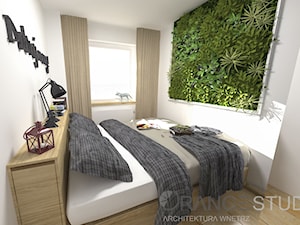 Mała sypialnia z łóżkiem na wymiar, wysuwanym cargo z wezgłowia oraz zieloną dekoracją ścienną - zdjęcie od ORANGE STUDIO