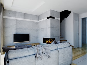 salon z kominkiem wykończony betonem architektonicznym - zdjęcie od Michał Ślusarczyk
