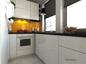 kuchnia w bieli z czarnym blatem i żółtym szkłem miedzy szafkami - zdjęcie od Michał Ślusarczyk