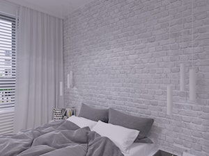 sypialnia ze ścianą z cegłą malowaną na biło. - zdjęcie od THE VIBE