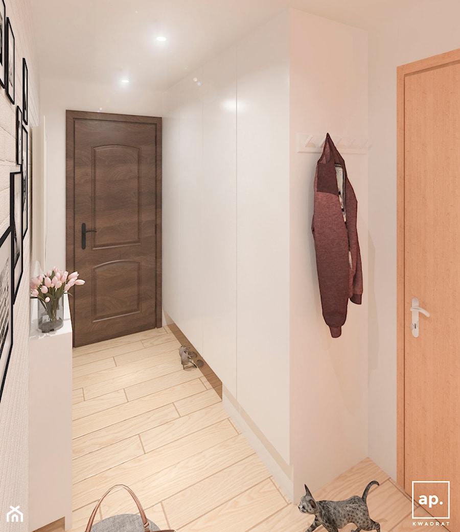 Mieszkanie Łódź - Mały z zabudową meblową z wieszakiem z prostokątnym lustrem biały z lustrem na ścianie z farbą na ścianie z drewnianymi drzwiami z frezowanymi drzwiami hol / przedpokój - zdjęcie od APkwadrat