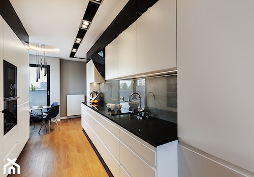 Apartament z betonem - Duża otwarta z kamiennym blatem szara z zabudowaną lodówką z podblatowym zlewozmywakiem kuchnia dwurzędowa z oknem, styl minimalistyczny - zdjęcie od ARCHITETTO