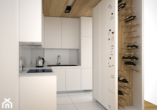 Miejsce w kuchni na butelki z winem - Mała otwarta biała z zabudowaną lodówką z podblatowym zlewozmywakiem kuchnia w kształcie litery l, styl minimalistyczny - zdjęcie od OES architekci
