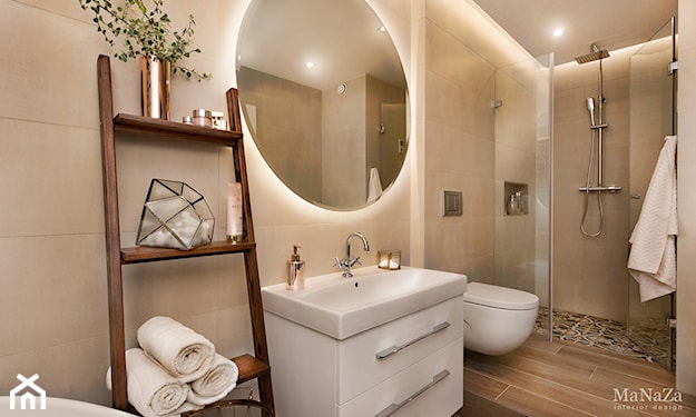 jasna łazienka z podświetlanym okrągłym lustrem