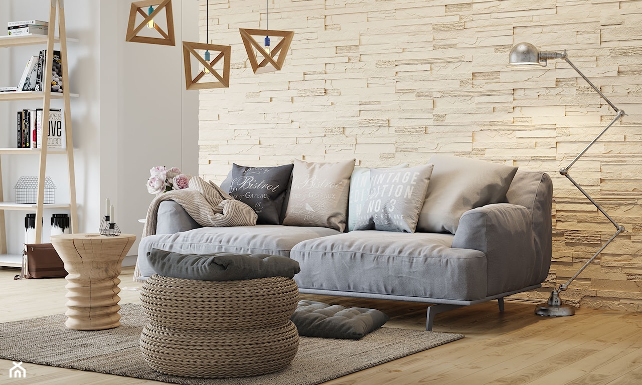 beżowy kamień dekoracyjny, metalowa lampa podłogowa, szara sofa na metalowych nóżkach, drewniany stolik, szary dywanik