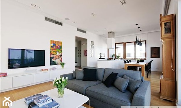 salon w stylu skandynawskim, szara sofa, drewniany stół, białe ściany