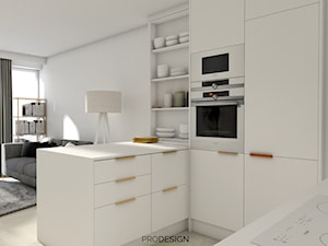MIESZKANIE_KRAKÓW_50m2 - Mała otwarta z salonem z kamiennym blatem biała z zabudowaną lodówką kuchnia w kształcie litery u z oknem, styl minimalistyczny - zdjęcie od PRODESIGN