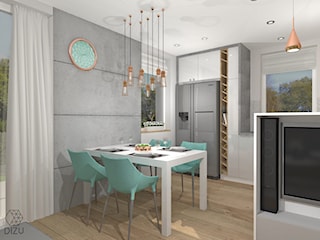 Otwarty salon z kuchnią z elementami betonu, miedzi i drewna.
