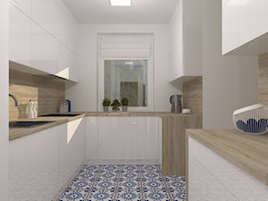 Kuchnia z niebiesko-białą mozaiką na podłodze - zdjęcie od DIZU Studio Projektowe