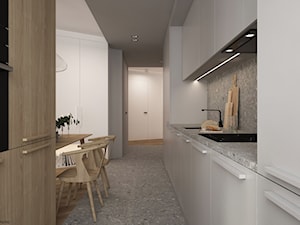Mieszkanie w Krakowie - Średnia otwarta z kamiennym blatem biała szara z zabudowaną lodówką z podblatowym zlewozmywakiem kuchnia dwurzędowa z kompozytem na ścianie nad blatem kuchennym z marmurową podłogą, styl minimalistyczny - zdjęcie od ELEMENTY