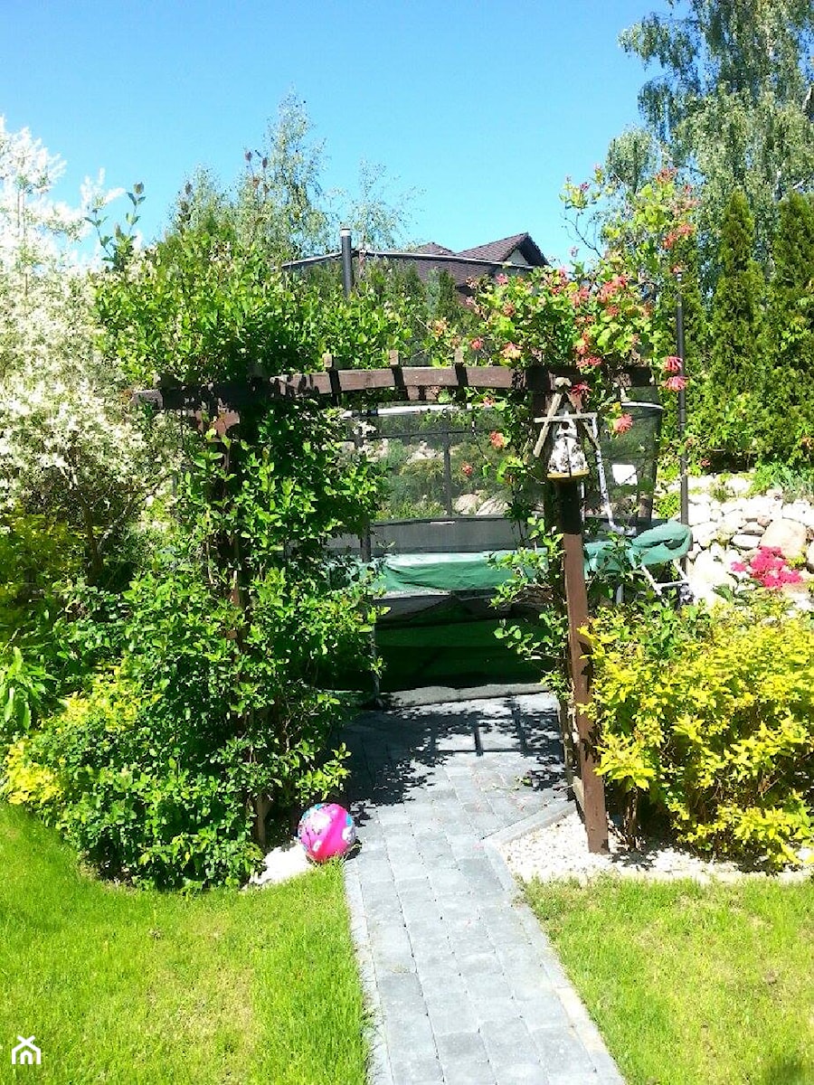COŚ DLA CIAŁA COŚ DLA DUSZY COŚ DLA OKA - Średni z nawierzchnią pokrytą kostką brukową ogród za domem z pergolą z trampoliną - zdjęcie od Marlena Hein