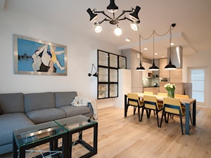 Projekt mieszkania w bloku. - Duży biały salon z kuchnią z jadalnią, styl nowoczesny - zdjęcie od MKdezere