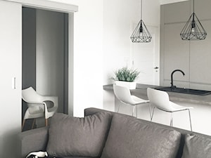 Kielce - mieszkania na wynajem - Średni biały salon z kuchnią z barkiem, styl minimalistyczny - zdjęcie od Pogotowie Wnętrzarskie