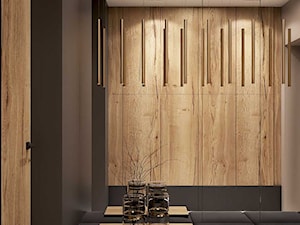 Wysmakowany dom w Pajęcznie - Mały z zabudową meblową z prostokątnym lustrem beżowy brązowy szary z lustrem na ścianie z farbą na ścianie z drzwiami przylgowymi z drewnianymi drzwiami z gładkimi drzwiami hol / przedpokój, styl nowoczesny - zdjęcie od MIKOŁAJSKAstudio