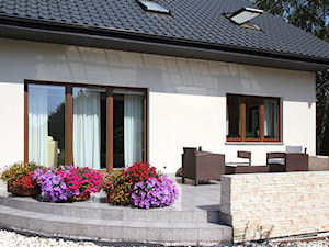 Okna - Średni z meblami ogrodowymi z donicami na kwiaty taras z tyłu domu, styl tradycyjny - zdjęcie od Stolbud Włoszczowa S.A./Grupa Koronea