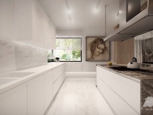 Dom w nowoczesnym stylu - Duża otwarta z kamiennym blatem biała z zabudowaną lodówką z podblatowym zlewozmywakiem kuchnia dwurzędowa z wyspą lub półwyspem z oknem, styl nowoczesny - zdjęcie od MKdesigner