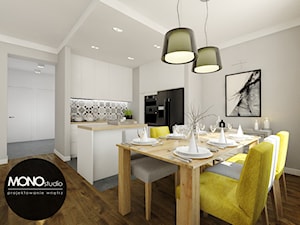 ​Nowoczesna otwarta na salon kuchnia w minimalistycznym charakterze z dodatkiem ciepłego drewna i koloru - zdjęcie od MONOstudio