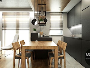 Salon z kuchnią w minimalistycznym i ciepłym charakterze - zdjęcie od MONOstudio