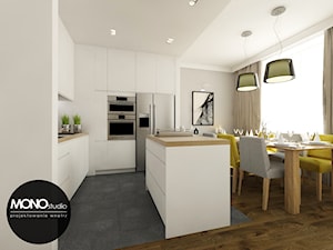 ​Nowoczesna otwarta na salon kuchnia w minimalistycznym charakterze z dodatkiem ciepłego drewna i koloru - zdjęcie od MONOstudio