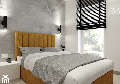 Sypialnia z betonową ścianą i żółtym łóżkiem - zdjęcie od Miliart Studio