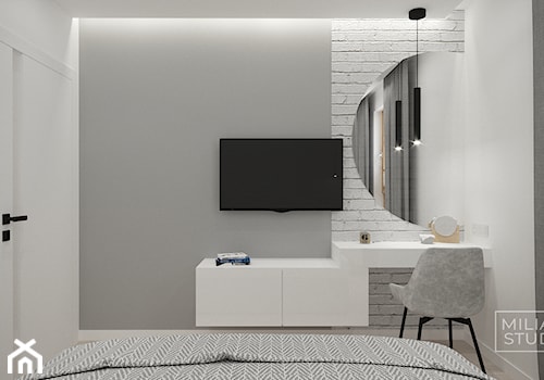 Jasna sypialnia z toaletką, okrągłym lustrem i cegiełką - zdjęcie od Miliart Studio
